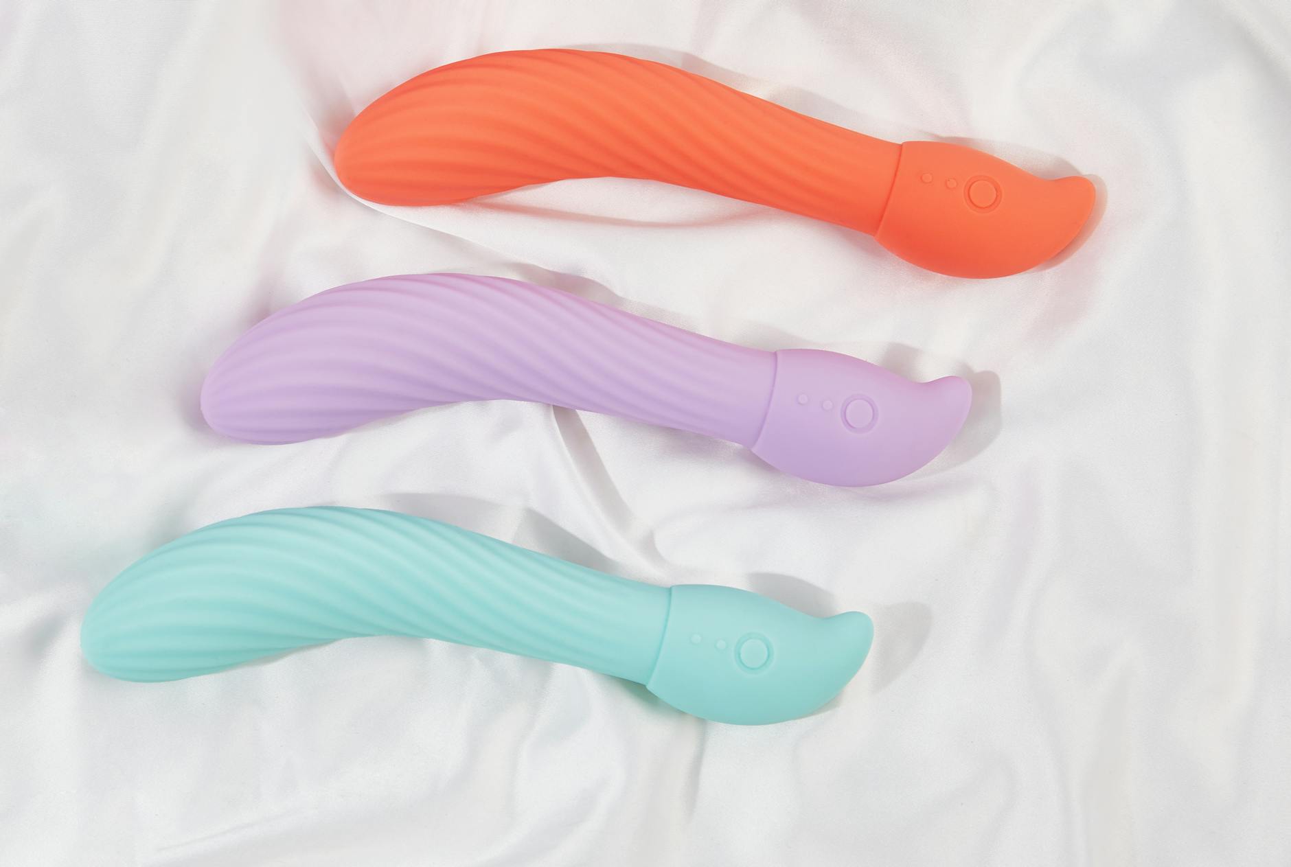 Woman holding vibrators thoughtfully, representing intentional healing and self-connection