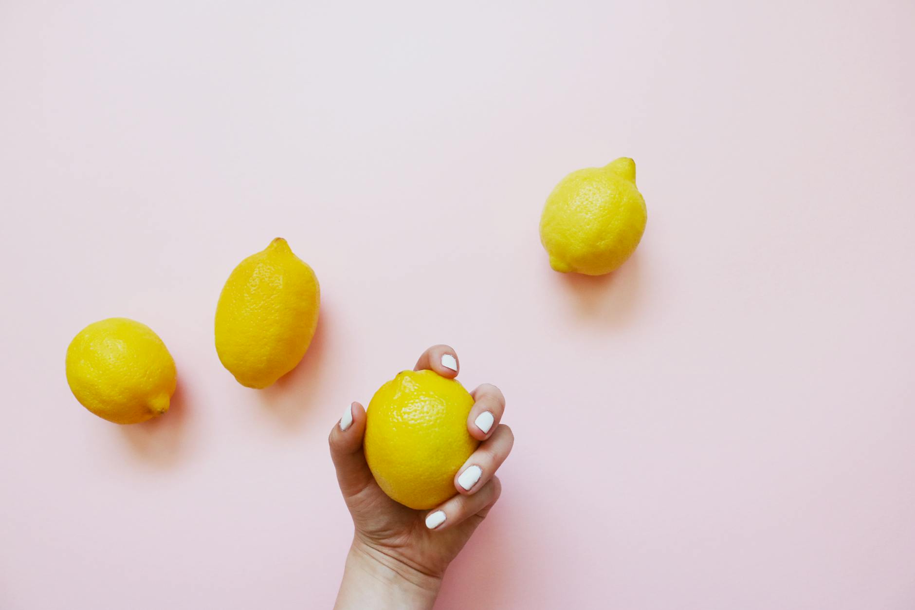 Fresh lemons arranged on a pastel background, symbolizing the bright, refreshing approach to exploring new pleasures